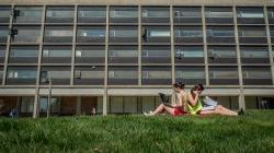 two students reading on the quad in front of Blanton Hall