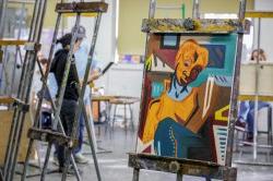 Vaguely Cubist student painting resting on easel in studio