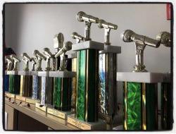 A row of trophies on a shelf for wmsc radio awards
