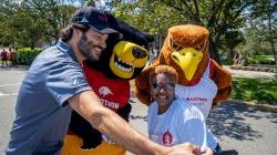 Rocky the Red Hawk and Deacon the Bear pose with President Koppell and Chancellor Evans