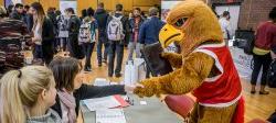 Image of Rocky the Red Hawk at a campus job fair.