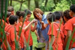 Teacher showing eco-explorers an animal in her hand